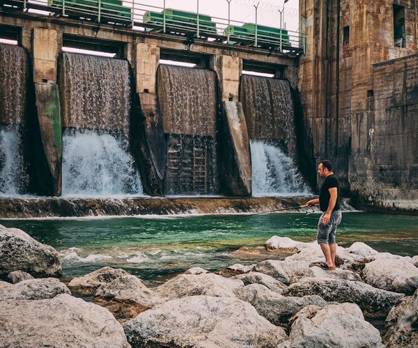 Silhouette of a man stretching against a backdrop with flowing energy lines.